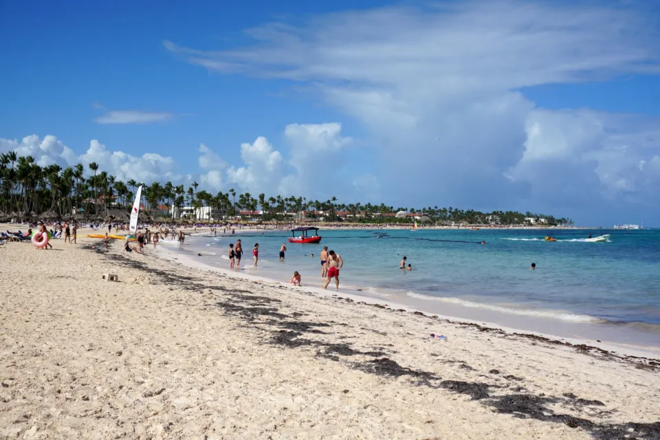 Langer weißer Sandstrand mit Palmen und türkisem Meer in Bávaro, Punta Cana.